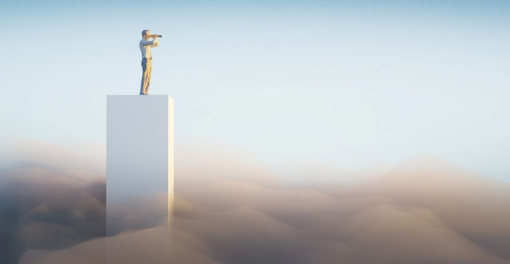 Man standing on a building with binoculoars